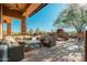 Inviting patio with comfortable seating, an outdoor fireplace, and views of the surrounding desert landscape at 28768 N 95Th Way, Scottsdale, AZ 85262