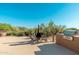 Outdoor seating area with custom grill, chiminea and desert landscaping at 28768 N 95Th Way, Scottsdale, AZ 85262