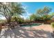Inviting pool area with mature desert landscaping and a patio with dining furniture at 28768 N 95Th Way, Scottsdale, AZ 85262