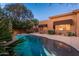 Tranquil backyard featuring a freeform pool, beautiful landscaping, and a glimpse of the home's exterior at twilight at 28768 N 95Th Way, Scottsdale, AZ 85262
