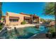 A beautiful pool is nestled next to the home with covered patio and desert landscaping at 28768 N 95Th Way, Scottsdale, AZ 85262