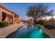 Beautiful backyard with a pool, outdoor living area, and lush desert landscaping, perfect for entertaining at 28768 N 95Th Way, Scottsdale, AZ 85262