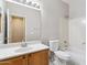 Bright bathroom featuring a wood vanity with white countertop, framed mirror, and a shower-tub combo at 3013 W Via De Pedro Miguel --, Phoenix, AZ 85086