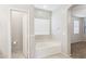 Bathroom featuring a soaking tub, tile floors, and a separate toilet room at 3013 W Via De Pedro Miguel --, Phoenix, AZ 85086