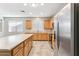 Well-lit kitchen featuring an island, wood cabinets and stainless steel appliances at 3013 W Via De Pedro Miguel --, Phoenix, AZ 85086