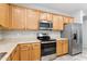 Kitchen with stainless steel appliances, wood cabinets and tiled flooring, plus ample counter space at 3013 W Via De Pedro Miguel --, Phoenix, AZ 85086