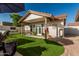 Inviting backyard with synthetic grass, covered patio, perfect for entertaining or relaxation at 3054 E Norwood St, Mesa, AZ 85213
