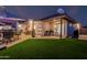 Beautiful backyard with manicured lawn, covered patios, and space for outdoor dining at 3054 E Norwood St, Mesa, AZ 85213