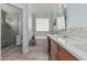Well-appointed bathroom with large soaking tub, glass-enclosed shower, and vanity with makeup area at 3054 E Norwood St, Mesa, AZ 85213