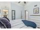 Comfortable bedroom with a ceiling fan, light blue walls, a mirror, and a comfortable bed at 3054 E Norwood St, Mesa, AZ 85213