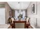 Elegant dining room with wood table, decorative chandelier, and natural light from the window at 3054 E Norwood St, Mesa, AZ 85213