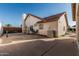 Rear exterior of a home featuring a stucco finish, tile roof, and gated driveway at 3054 E Norwood St, Mesa, AZ 85213