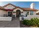 Inviting single-story home with well-manicured landscaping, terracotta roof, and cozy front porch at 3054 E Norwood St, Mesa, AZ 85213