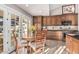 Charming eat-in kitchen featuring granite countertops, wood cabinetry, and access to the patio at 3054 E Norwood St, Mesa, AZ 85213