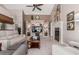 Spacious living room with built-in shelves, a fireplace, and a ceiling fan at 3054 E Norwood St, Mesa, AZ 85213