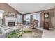 Comfortable living room featuring a fireplace, vaulted ceilings, and large windows for natural light at 3054 E Norwood St, Mesa, AZ 85213