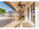 Covered patio with outdoor seating area, ceiling fans, and views of the backyard pool and landscaping at 3054 E Norwood St, Mesa, AZ 85213
