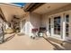 Covered patio area featuring ceiling fans, wicker furniture, and built-in grills, perfect for outdoor entertaining at 3054 E Norwood St, Mesa, AZ 85213