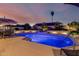 Stunning backyard pool with lighting, desert landscaping, and sunset views at 3054 E Norwood St, Mesa, AZ 85213