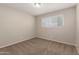 Bedroom featuring a window letting in natural light and neutral tones at 3118 W Aster Dr, Phoenix, AZ 85029