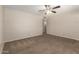 Comfortable living room featuring neutral walls, carpet flooring, a ceiling fan, and an open layout at 3118 W Aster Dr, Phoenix, AZ 85029