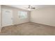 Inviting living room features neutral walls, carpet flooring, a ceiling fan, and ample natural light at 3118 W Aster Dr, Phoenix, AZ 85029