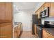 Traditional kitchen featuring wood cabinets, stainless steel appliances, and tile flooring at 3314 N 68Th St # 129, Scottsdale, AZ 85251