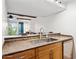 Kitchen featuring a serving bar, stainless steel sink and faucet, and built in dishwasher at 3314 N 68Th St # 129, Scottsdale, AZ 85251
