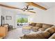 Spacious living room with a large sofa, exposed beams and a sliding glass door to the patio at 3314 N 68Th St # 129, Scottsdale, AZ 85251