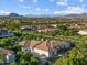 Beautiful aerial view featuring the property in a lush neighborhood with mountain views at 3354 E Jaeger Cir, Mesa, AZ 85213