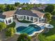 Aerial shot of home, pool, patio, and firepit with lush landscaping and blue skies at 3354 E Jaeger Cir, Mesa, AZ 85213