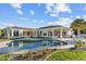 A stunning backyard featuring a pool, patio, lush landscaping, and a luxurious home at 3354 E Jaeger Cir, Mesa, AZ 85213