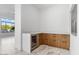 Convenient bar area featuring custom cabinets, countertops, and a modern built-in cooler at 3354 E Jaeger Cir, Mesa, AZ 85213