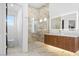 Elegant bathroom with walk-in shower, marble accents, glass door, and modern vanity with LED mirror at 3354 E Jaeger Cir, Mesa, AZ 85213