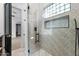 Shower design boasting stylish patterned tiles, glass doors, and integrated storage niches at 3354 E Jaeger Cir, Mesa, AZ 85213