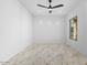 Bright bedroom featuring a ceiling fan, large format tile flooring, and natural light at 3354 E Jaeger Cir, Mesa, AZ 85213