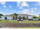 Charming single-story home with a manicured lawn and inviting front entrance featuring stone accents and a tile roof at 3354 E Jaeger Cir, Mesa, AZ 85213
