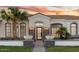 Inviting front entrance with stone accents, manicured landscaping and a modern glass front door at 3354 E Jaeger Cir, Mesa, AZ 85213