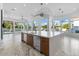 Bright kitchen features a large marble island, stainless steel appliances, and backyard views at 3354 E Jaeger Cir, Mesa, AZ 85213