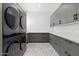 Well-designed laundry room boasts modern washer/dryer units, ample cabinet space, and stylish flooring at 3354 E Jaeger Cir, Mesa, AZ 85213