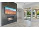Open-concept living room featuring a fireplace, decorative tile, and patio access at 3354 E Jaeger Cir, Mesa, AZ 85213