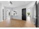 Sun-drenched living area showcasing beautiful herringbone floors and black doors at 3354 E Jaeger Cir, Mesa, AZ 85213