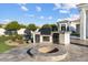 Entertain outdoors with a full kitchen setup and a cozy fire pit on a paved patio, perfect for gatherings at 3354 E Jaeger Cir, Mesa, AZ 85213