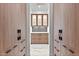Well-organized walk-in pantry with custom cabinets, marble countertops, and ample storage space at 3354 E Jaeger Cir, Mesa, AZ 85213