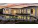 Stunning outdoor pool surrounded by lush landscaping, elegant lighting, and a spacious patio area at 3354 E Jaeger Cir, Mesa, AZ 85213