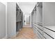 Spacious walk-in closet with custom shelving, drawers, mirrored accents, and herringbone floors at 3354 E Jaeger Cir, Mesa, AZ 85213