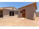 Expansive backyard showcasing the main house and guest house with a mix of hardscape and natural desert landscape at 3539 W Davidson Ln, Phoenix, AZ 85051