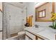 Cozy bathroom featuring a tiled shower, vanity with sink, and neutral decor at 3539 W Davidson Ln, Phoenix, AZ 85051