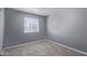 A bright bedroom with neutral carpeting and a window allowing ample natural light at 3539 W Davidson Ln, Phoenix, AZ 85051