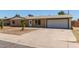Charming single-story home with a brick facade, attached garage, and well-manicured front yard at 3539 W Davidson Ln, Phoenix, AZ 85051
